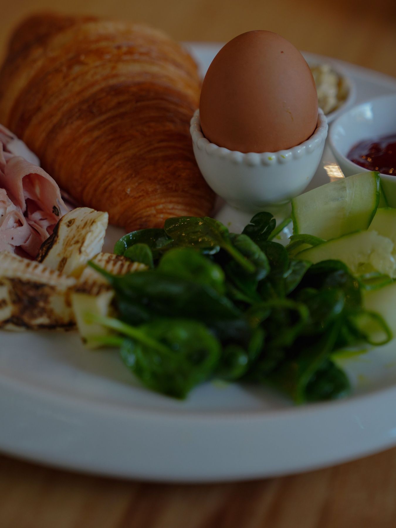 Croissant, boiled egg, halloumi and greens